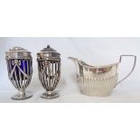 A pair of damaged silver condiments - sold with a Chester silver cream jug - dents