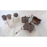 Three silver condiments and various silver topped bottles