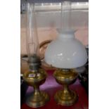 Two Aladdin table oil lamps, both with chimneys, one with white opaque shade