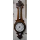 A late Victorian stained and carved oak banjo barometer/thermometer a/f