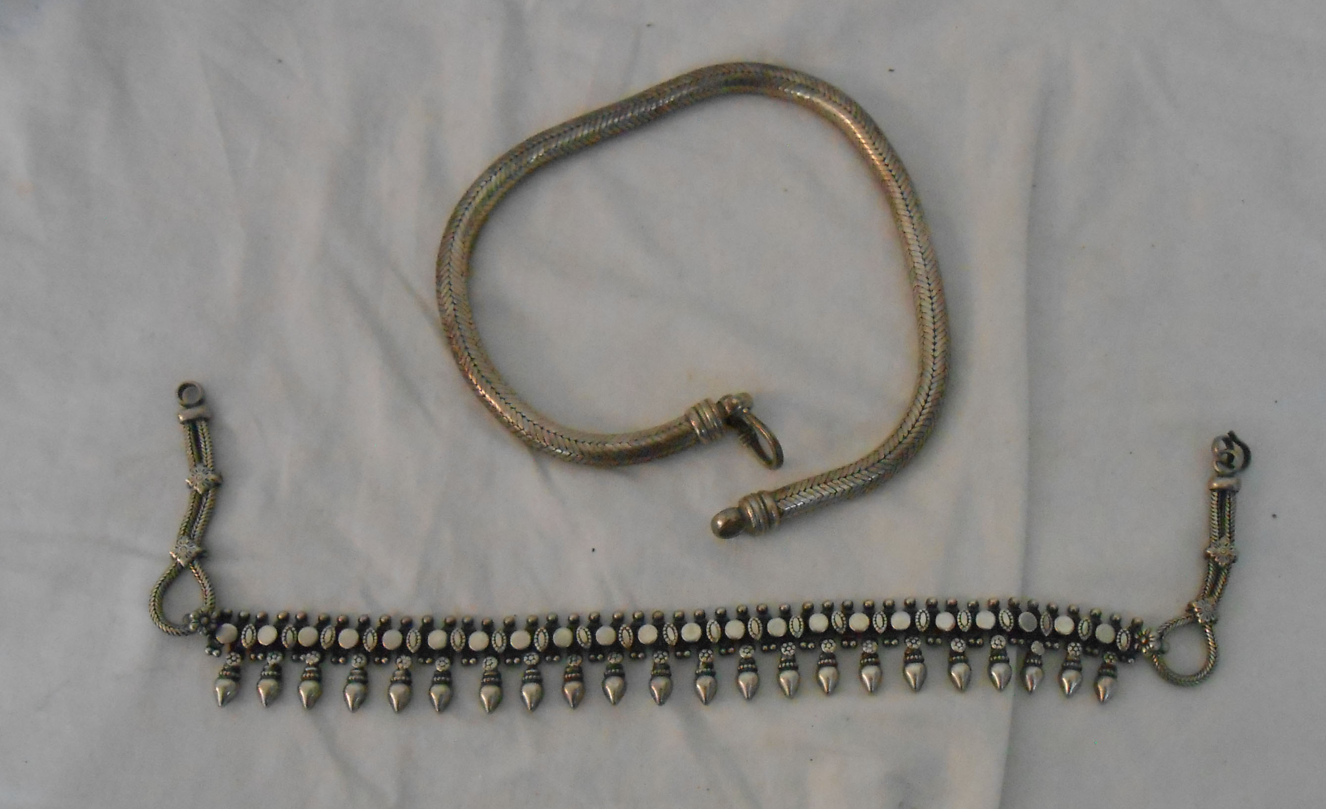 A heavy Indian white metal snake-link choker necklace - sold with an ornate beaded similar