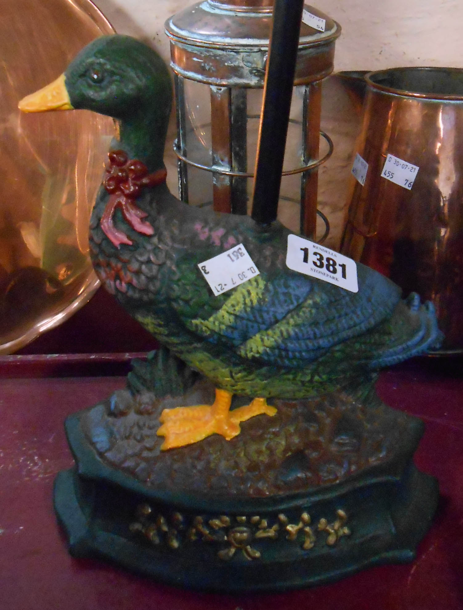 A modern cast iron painted duck form door stop