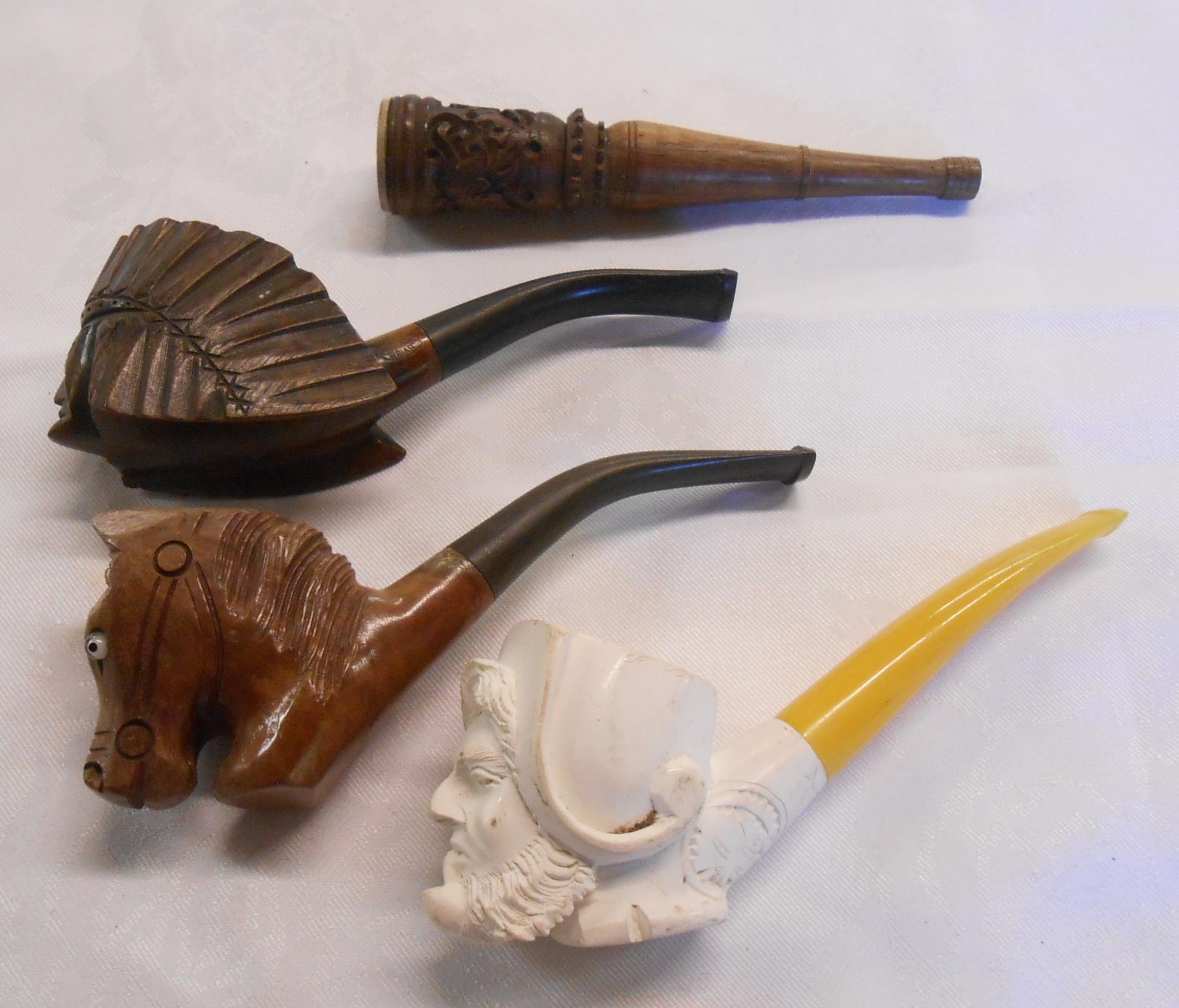 A Meerschaum pipe carved as a man smoking a pipe with amber stem - sold with a carved briar wood