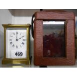 A brass and bevelled glass cased carriage timepiece with Roman numerals and eight day movement, in a