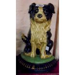 A cast metal and painted doorstop in the form of a seated collie dog