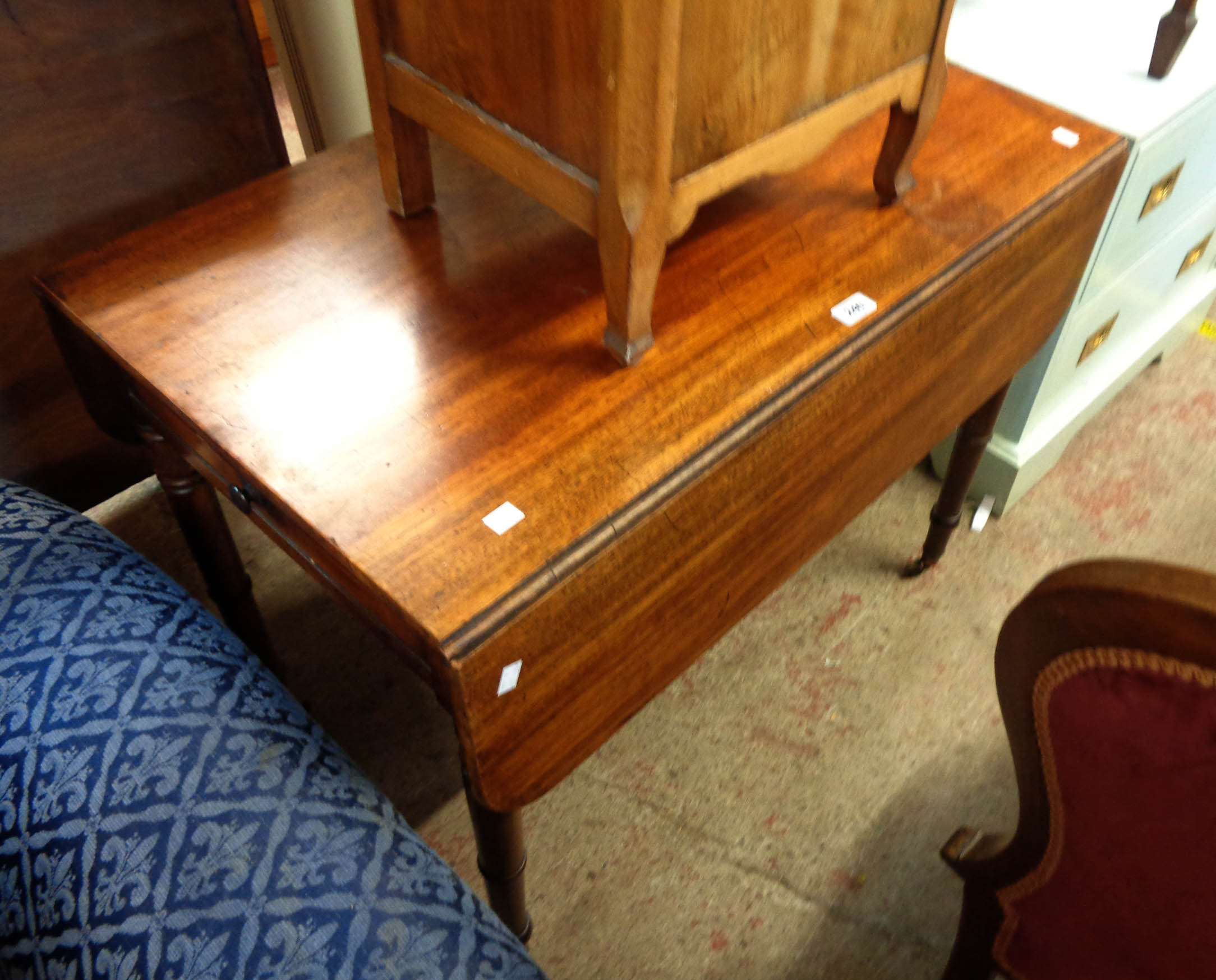 A 90cm 19th Century mahogany Pembroke table with drawer and opposing dummy drawer front, set on ring