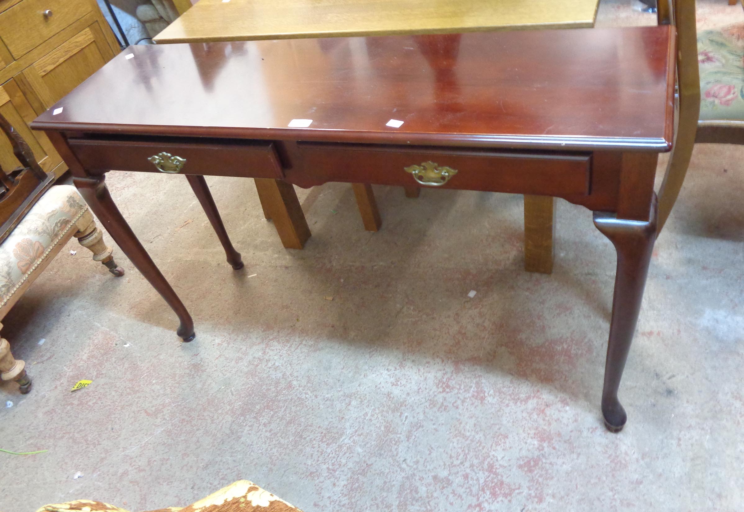 A 1.2m reproduction mahogany hall table with two frieze drawers, set on moulded legs with pad feet
