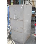 A vintage grey metal painted three drawer filing cabinet