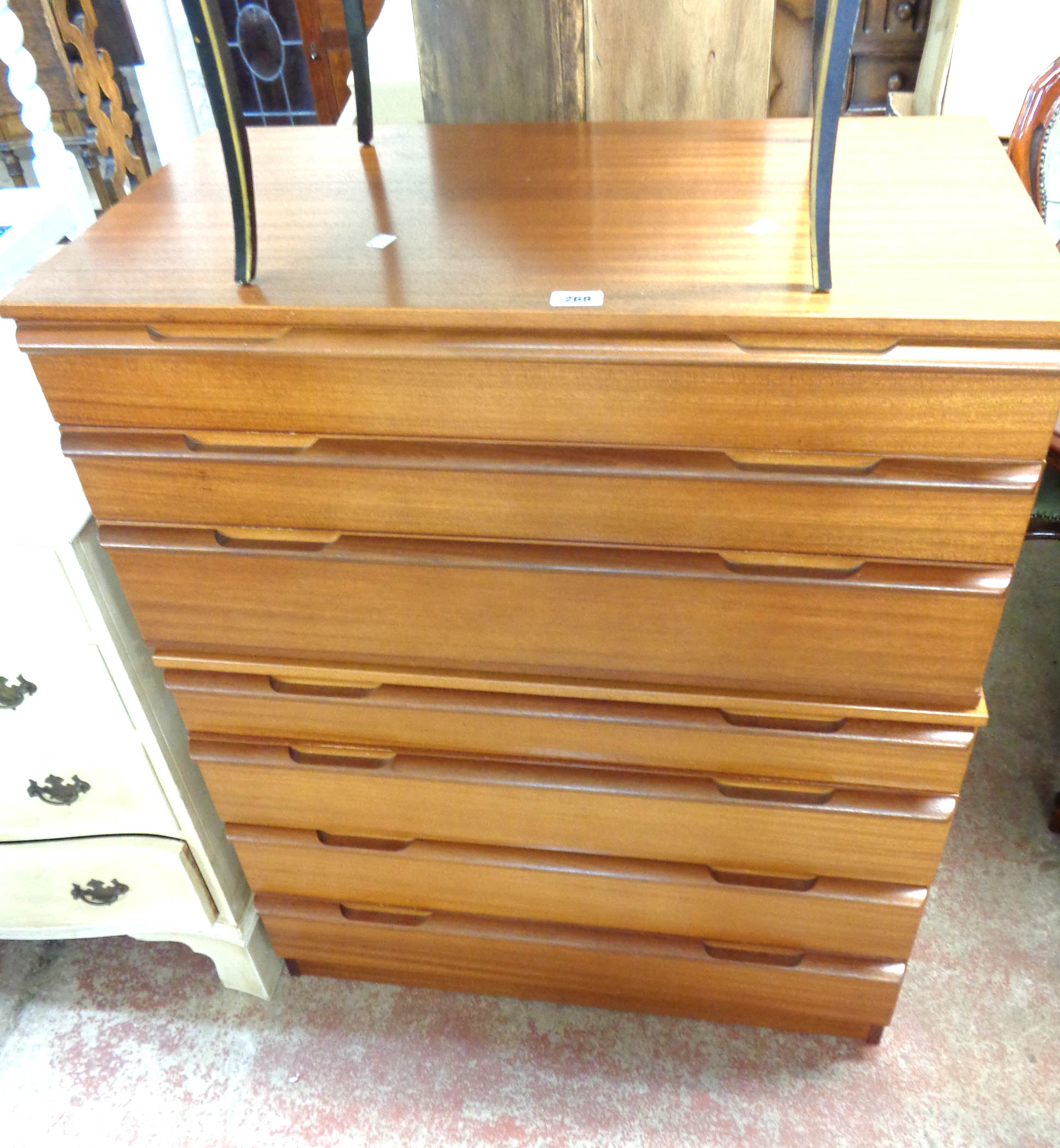 An 82cm retro Avalon teak effect two part chest of seven graduated drawers, set on plinth base