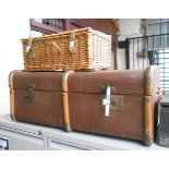 A vintage cane bound and canvas weather coated travelling trunk - sold with a modern wicker picnic