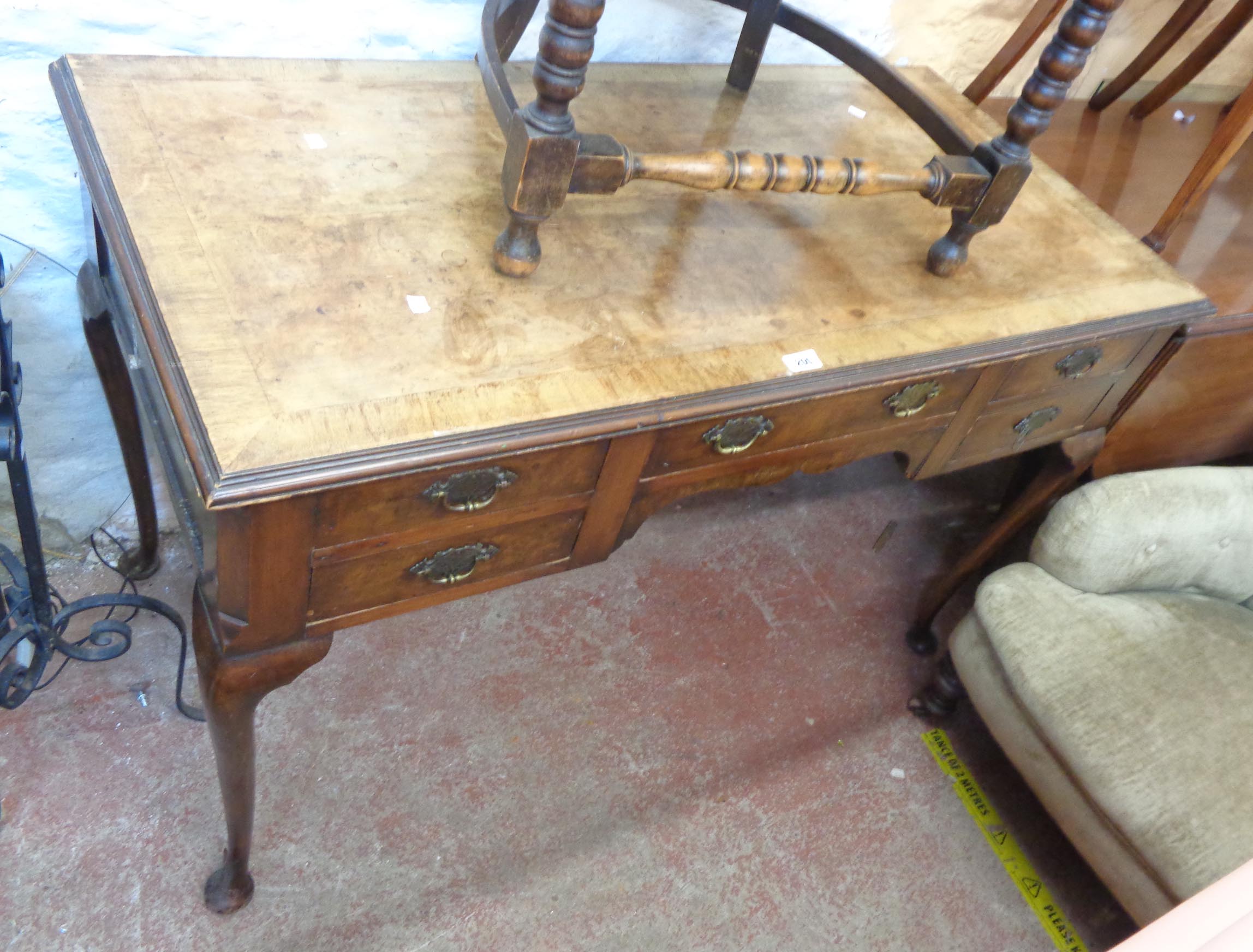 A 1.25m antique figured walnut and cross banded kneehole desk with central frieze drawer and four