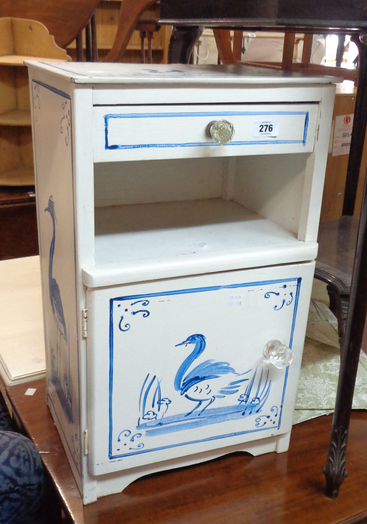 A 37cm painted mixed wood bedside cabinet with heron decoration, drawer, recess and door under