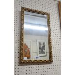 A small reproduction ornate gilt framed oblong wall mirror