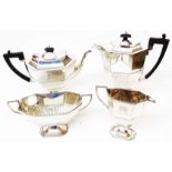 A silver four piece tea set of faceted and semi-fluted design, bearing presentation text - teapot