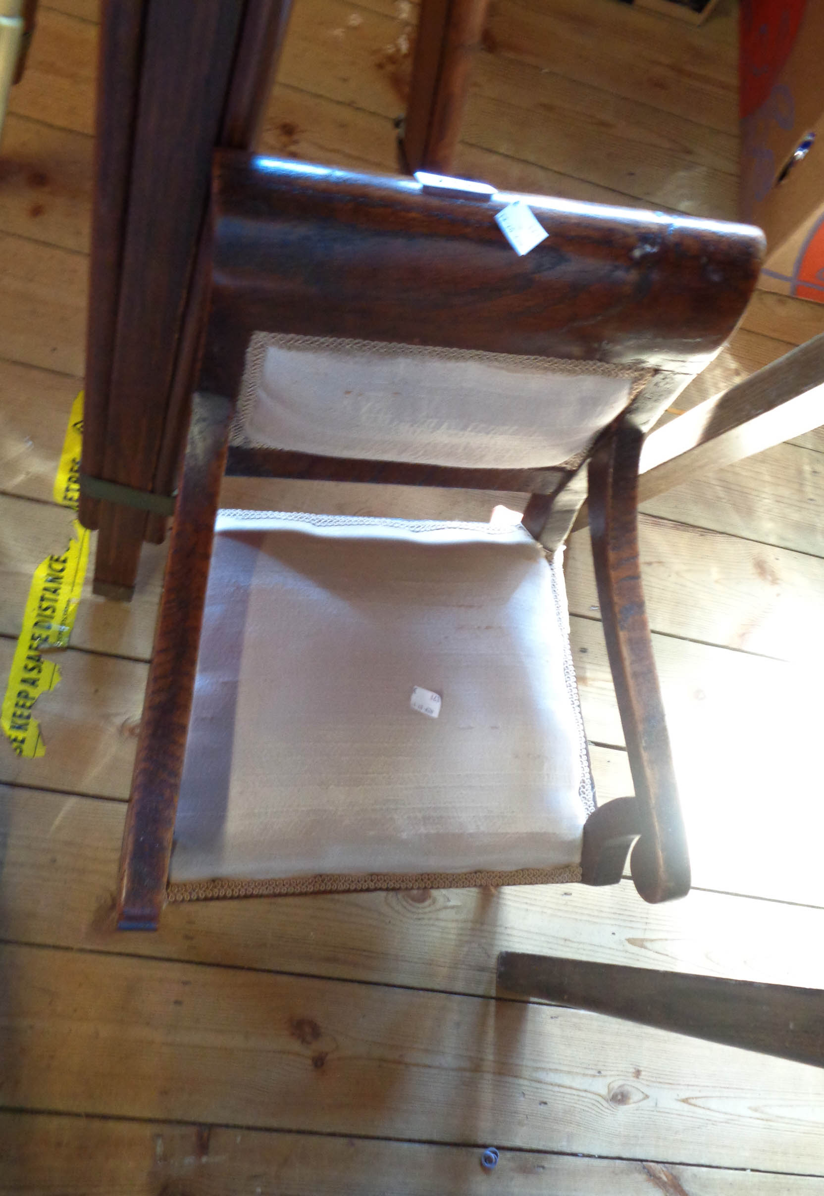 An antique oak framed child's elbow chair with upholstered back, set on sabre legs