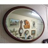 An Edwardian mahogany and strung bevelled oval wall mirror