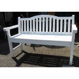 A two seater wooden white painted garden bench