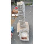 An old granite bird bath on cut pillar stand with base - top detached but present