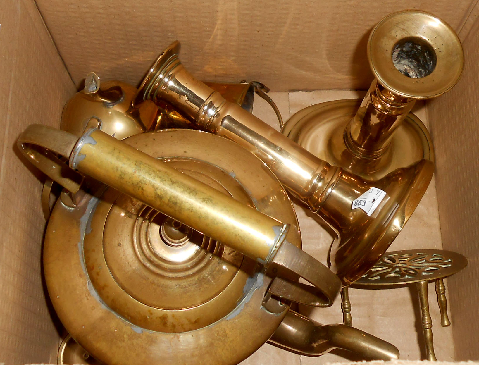 A box containing a pair of 19th Century candlesticks, brass kettle, etc.