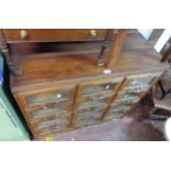 A 92cm vintage mixed wood multi-drawer haberdashery unit with three flights of four glass fronted