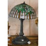 A modern cast metal column form table lamp with decorative Tiffany style shade