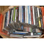 A bag containing assorted CDs including Elton John, Red Hot Chili Peppers, etc.