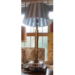 A large Corinthian column cast brass table lamp set on stepped marble and slate plinth