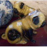 A pair of hollow cast pottery pug dog figurines - one a/f to leg