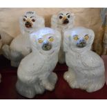 A pair of 19th Century Staffordshire Comforter spaniels with glass eyes - sold with another