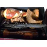 A box of carved wooden items including Black Forest style dog, crocodiles, etc.