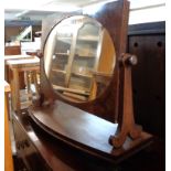 A Victorian mahogany platform dressing table mirror with oval plate, reeded supports and bow front