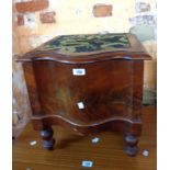 A Victorian mahogany serpentine front step commode with china liner, set on turned legs
