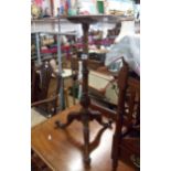 A mahogany wine table with ornate turned pillar and tripod base - marriage