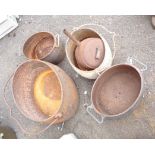 A selection of old cast iron cooking pots and saucepans including ten gallon cooking pot, etc.