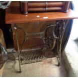 An old cast iron Singer sewing machine base, with later wooden top as a table