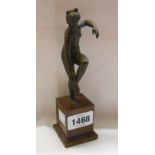 An antique bronze figure depicting a maiden in naturalistic pose on later wooden plinth