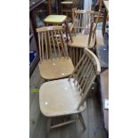 A set of four retro dining chairs with moulded laminated seats, set on simple turned supports -