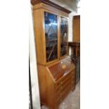 A 90cm early 20th Century mahogany and strung bureau/bookcase with astragal glazed top over fitted