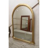 A reproduction gilt framed Victorian style dome-top bevelled wall mirror