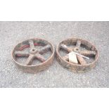 A pair of old cast iron trolley wheels