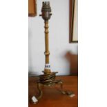 An Edwardian cast brass triple footed table lamp