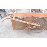 An antique Planet Jr. wood and metal seed drill