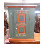 A 56cm mid 20th Century Scandinavian painted pine cupboard in the antique style with text to front -