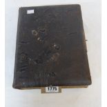 A late Victorian tooled leather cabinet photo album containing posed family portraits and groups