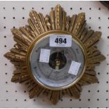 A small vintage gilt resin starburst wall barometer by Shortland Smiths with visible aneroid works