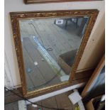 An ornate gilt framed bevelled oblong wall mirror