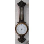 A late Victorian carved oak cased banjo barometer/thermometer, the dial marked for Ford of