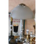 A modern brushed metal mid Century style table lamp with holophane style frosted shade