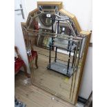 A reproduction Art Deco style multi bevelled plate wall mirror with stepped shaped top and double