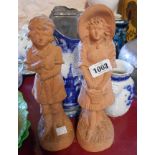 A pair of Victorian terracotta figurines - sold with a blue and white hot water jug and toothbrush